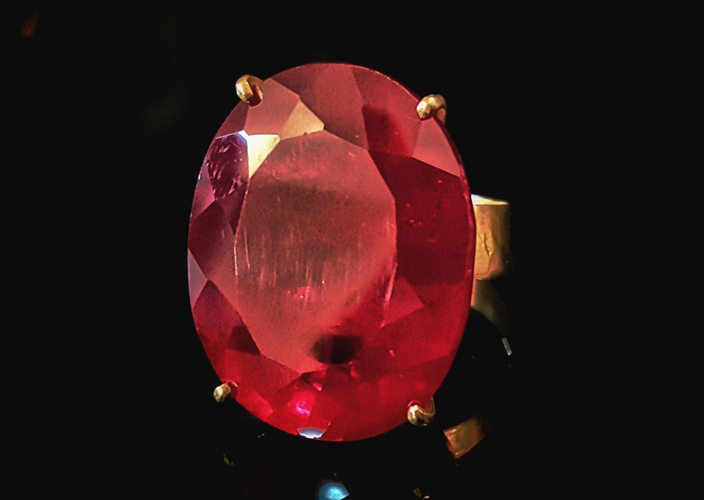 18k Yellow Gold Rubellite Ring, Large Oval Rubellite and wide band ring in a black background