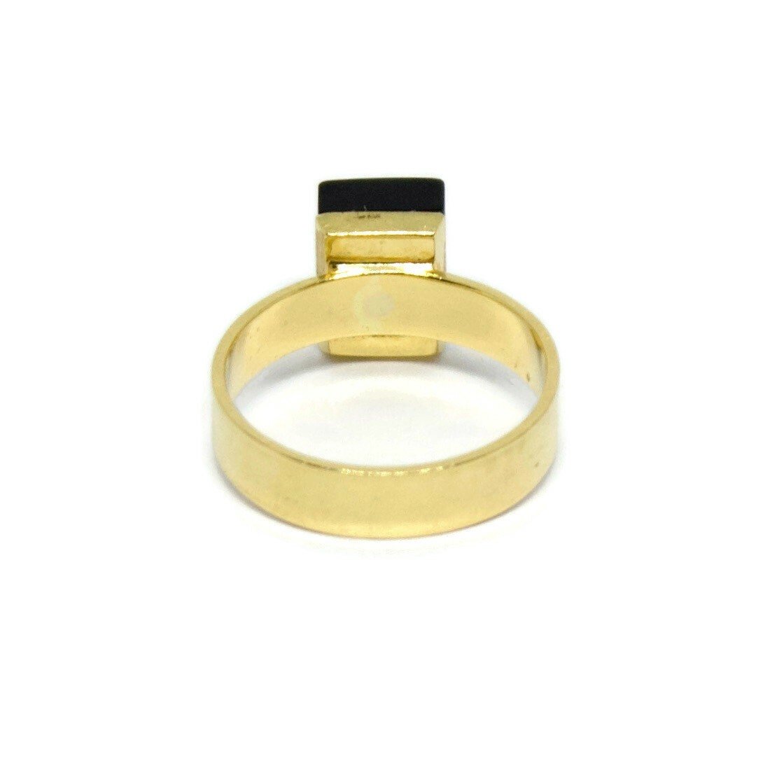 Black Onyx and Diamond Gold Cocktail Ring. Made from 18k solid gold, this statement ring has a black onyx stone with a diamond at its heart.